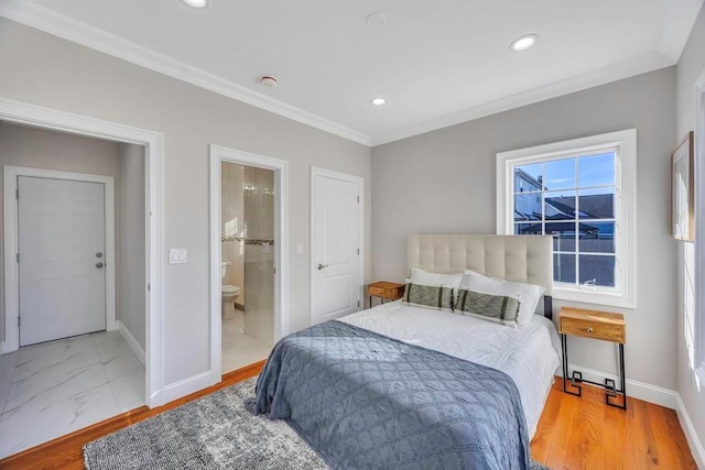 bedroom featuring ensuite bath, ornamental molding, and light hardwood / wood-style floors