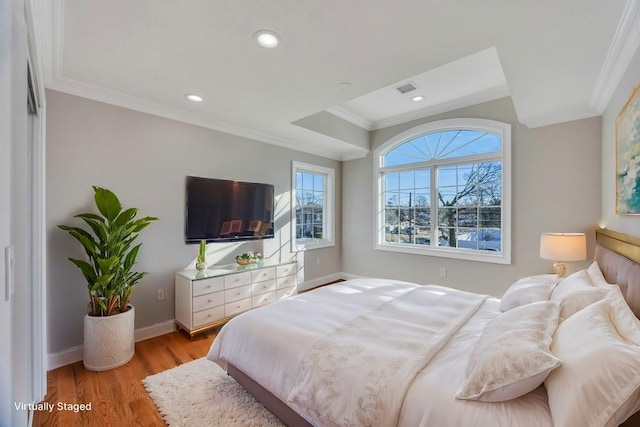 bedroom featuring ornamental molding and light wood-type flooring