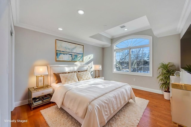 bedroom featuring crown molding and hardwood / wood-style floors