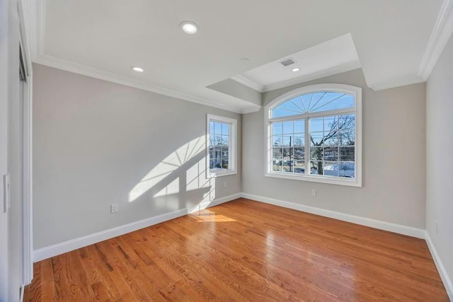 empty room featuring crown molding and light hardwood / wood-style floors