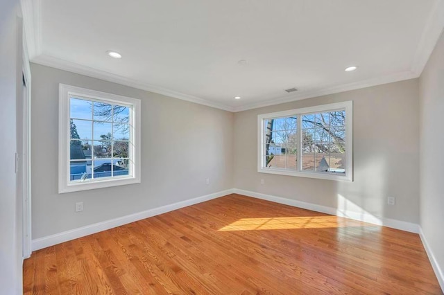 unfurnished room with crown molding and light hardwood / wood-style flooring