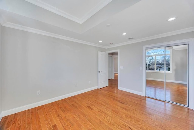 unfurnished bedroom with light hardwood / wood-style flooring, ornamental molding, and a closet