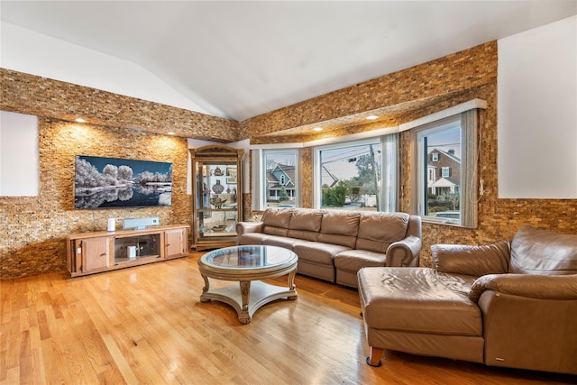 living room with wood-type flooring and vaulted ceiling