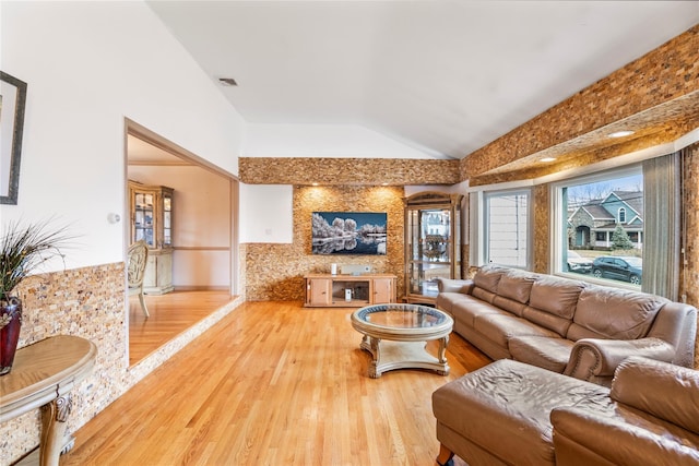 living room featuring hardwood / wood-style flooring and vaulted ceiling