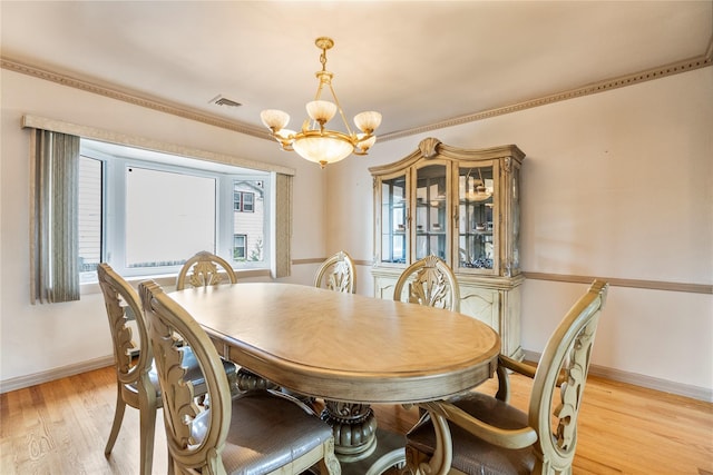 dining room featuring an inviting chandelier and light hardwood / wood-style flooring