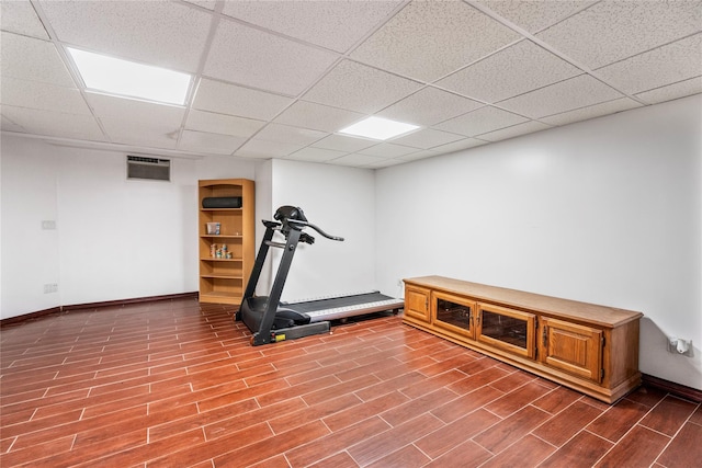 workout room with hardwood / wood-style floors and a paneled ceiling