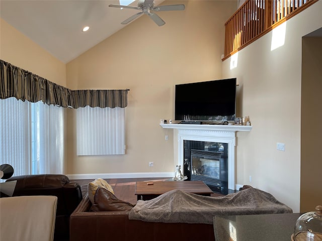 living room with ceiling fan and high vaulted ceiling