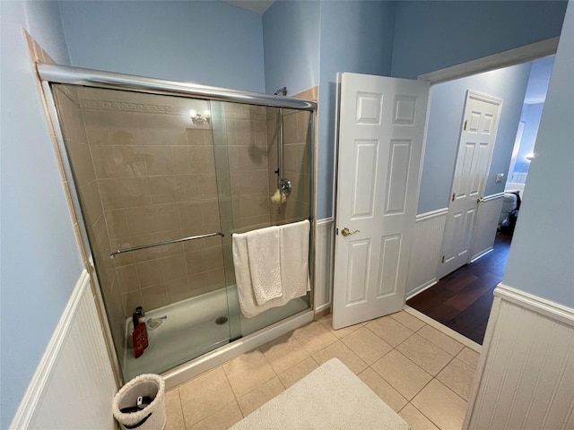 bathroom with walk in shower and tile patterned floors