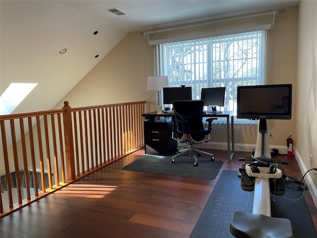 home office with lofted ceiling with skylight and dark wood-type flooring