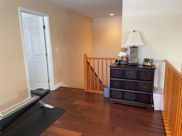 exercise room featuring dark wood-type flooring