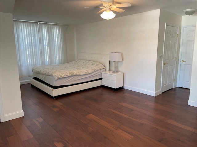 unfurnished bedroom featuring ceiling fan and dark hardwood / wood-style floors