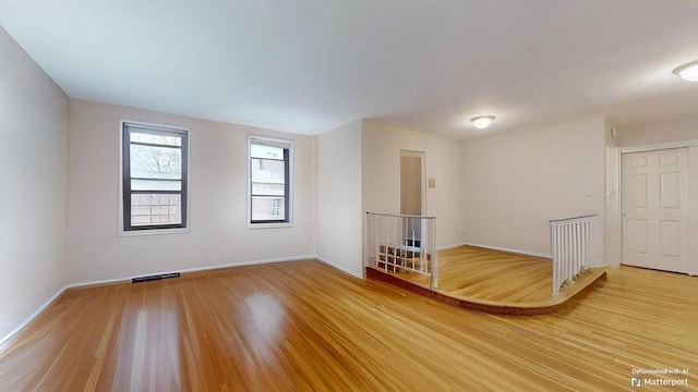 empty room with wood-type flooring