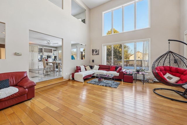 living room with a high ceiling and light wood-type flooring