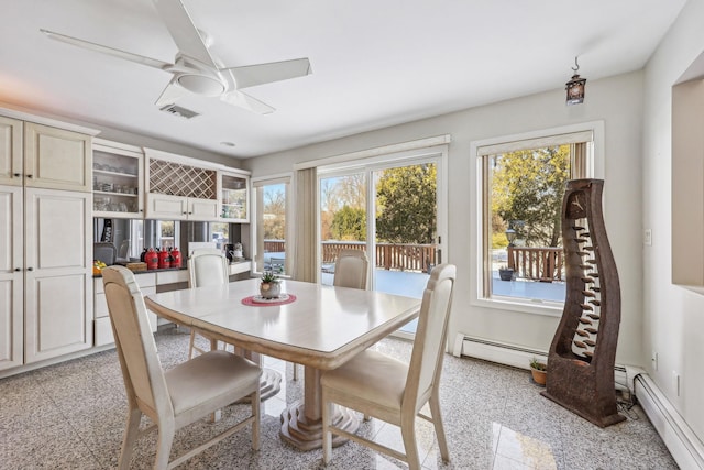 dining room with baseboard heating, ceiling fan, and a wealth of natural light