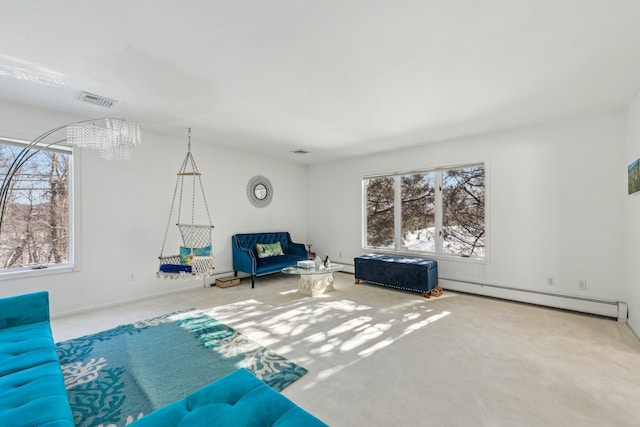 unfurnished living room featuring a baseboard heating unit and carpet