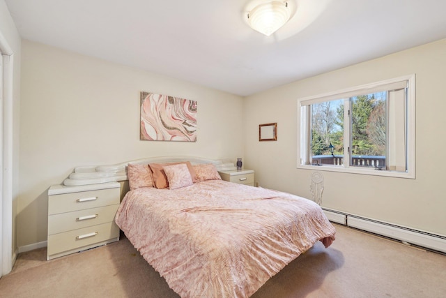 bedroom with baseboard heating and light colored carpet