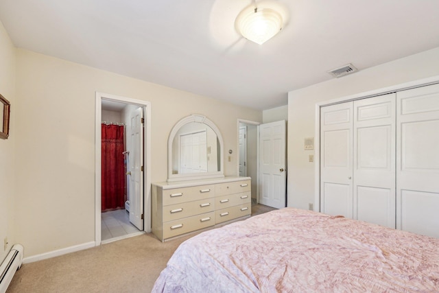 bedroom with a baseboard radiator, light carpet, ensuite bath, and a closet