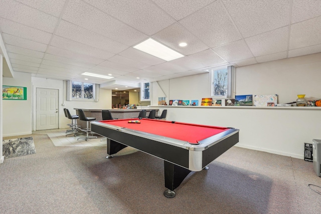 game room featuring a drop ceiling, carpet flooring, and indoor bar