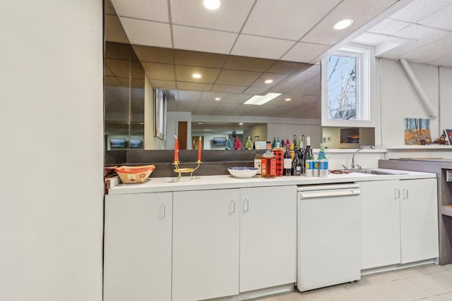 kitchen featuring white cabinetry, a paneled ceiling, and sink