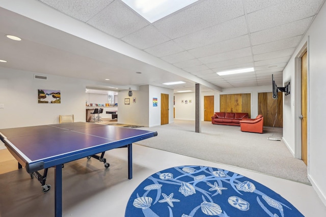 recreation room featuring carpet floors and a drop ceiling