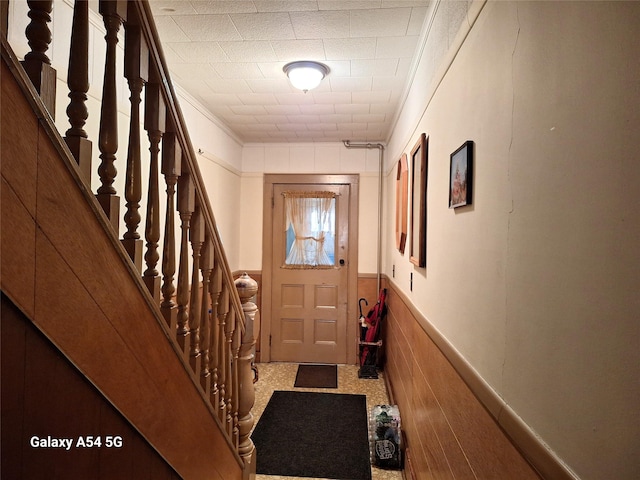 doorway featuring wood walls