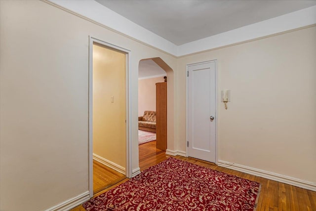 hallway with hardwood / wood-style flooring