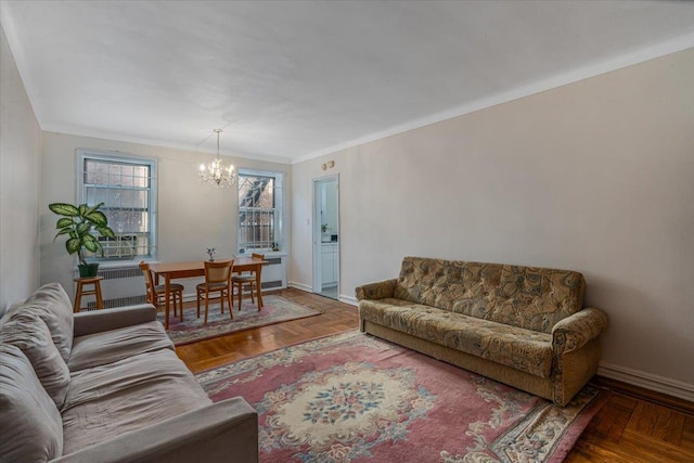 living room featuring ornamental molding, parquet flooring, and a notable chandelier