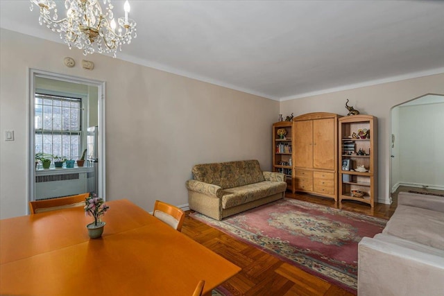 living room featuring an inviting chandelier, radiator, and parquet flooring