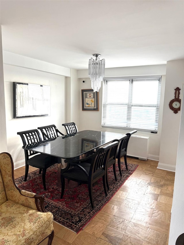 dining area featuring an inviting chandelier and light parquet floors