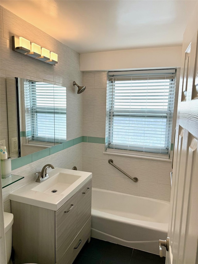 full bathroom featuring vanity, a wealth of natural light, tile patterned floors, and toilet