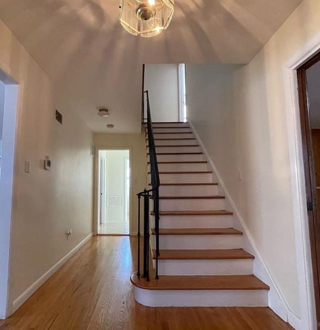 stairs featuring wood-type flooring