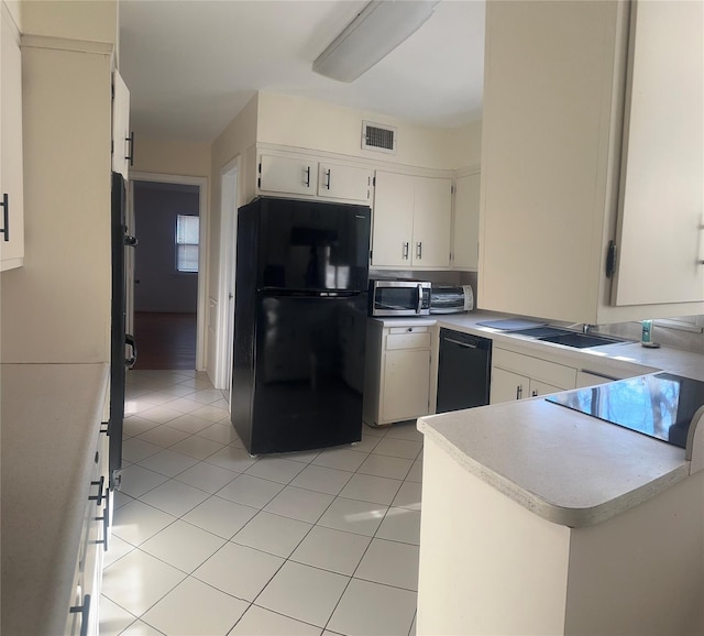 kitchen with white cabinetry, light tile patterned flooring, kitchen peninsula, and black appliances