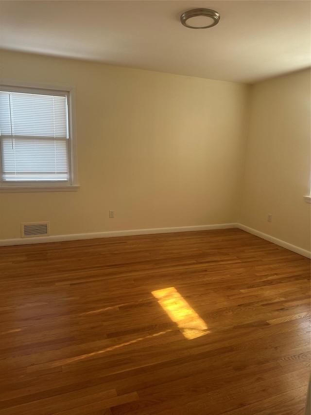 spare room featuring dark wood-type flooring