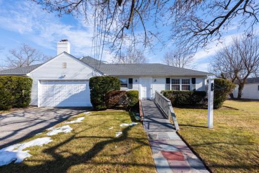 ranch-style house with a garage and a front yard