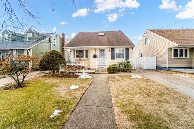 bungalow-style house with covered porch and a front yard