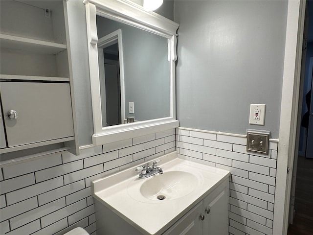 bathroom featuring vanity and tile walls