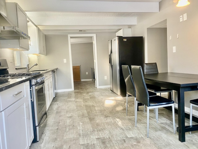 kitchen featuring extractor fan, appliances with stainless steel finishes, white cabinets, backsplash, and light hardwood / wood-style floors