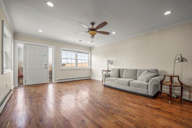 living room featuring a baseboard heating unit, crown molding, and dark wood-type flooring