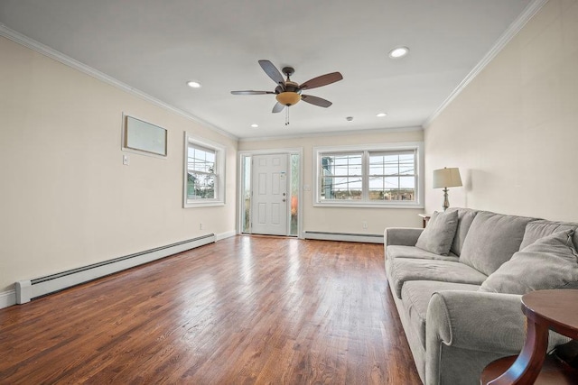 living room with hardwood / wood-style flooring, a healthy amount of sunlight, and baseboard heating