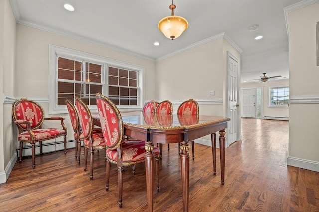 dining room featuring a baseboard radiator, ornamental molding, and hardwood / wood-style floors