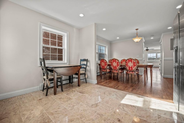 dining room featuring crown molding and a baseboard radiator