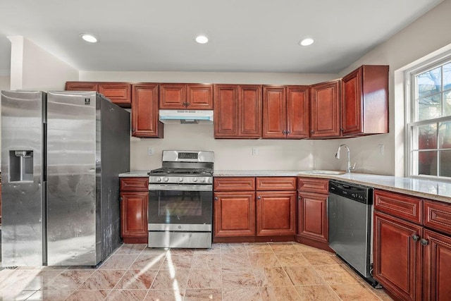 kitchen with light stone counters, sink, and stainless steel appliances