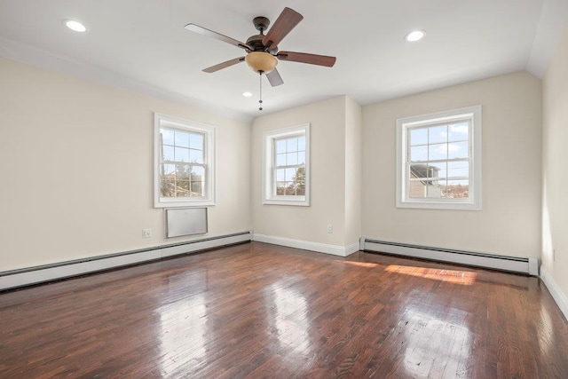 empty room with a baseboard radiator, a healthy amount of sunlight, and dark wood-type flooring