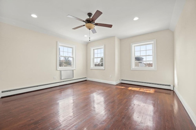 unfurnished room featuring ceiling fan, dark hardwood / wood-style floors, and a baseboard heating unit