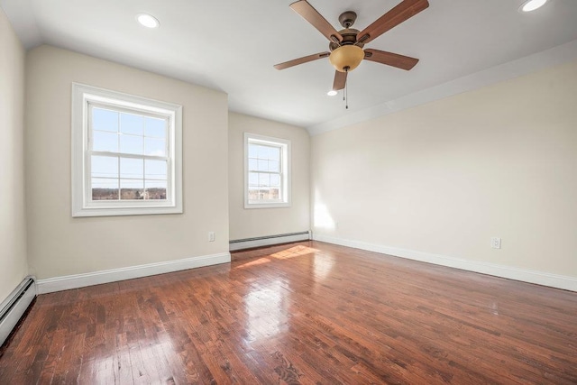 empty room featuring ceiling fan, a baseboard heating unit, and dark hardwood / wood-style floors