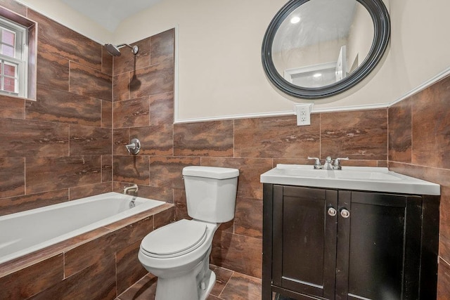 full bathroom with tiled shower / bath, tile walls, vanity, and toilet