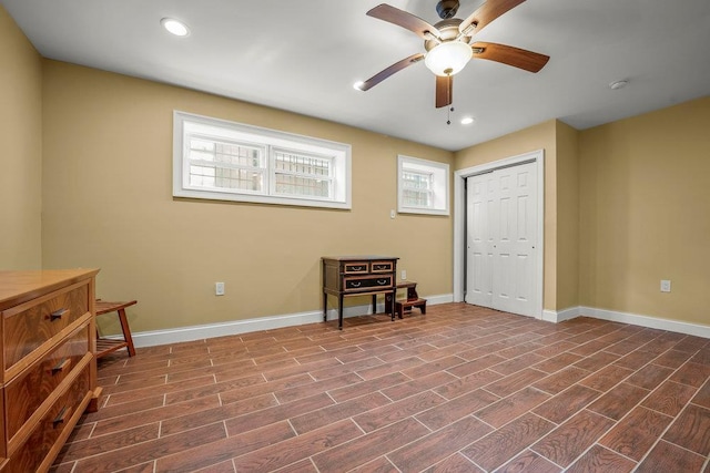 interior space featuring ceiling fan and a closet