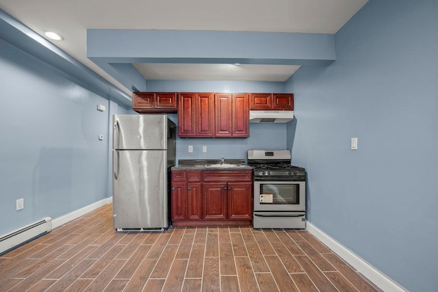 kitchen with baseboard heating, appliances with stainless steel finishes, and sink