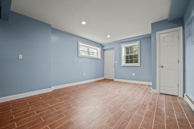 interior space with wood-type flooring and a baseboard radiator