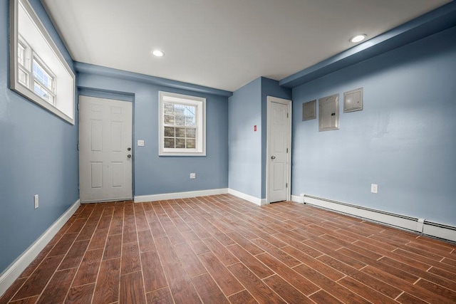 interior space featuring plenty of natural light, a baseboard radiator, and wood-type flooring